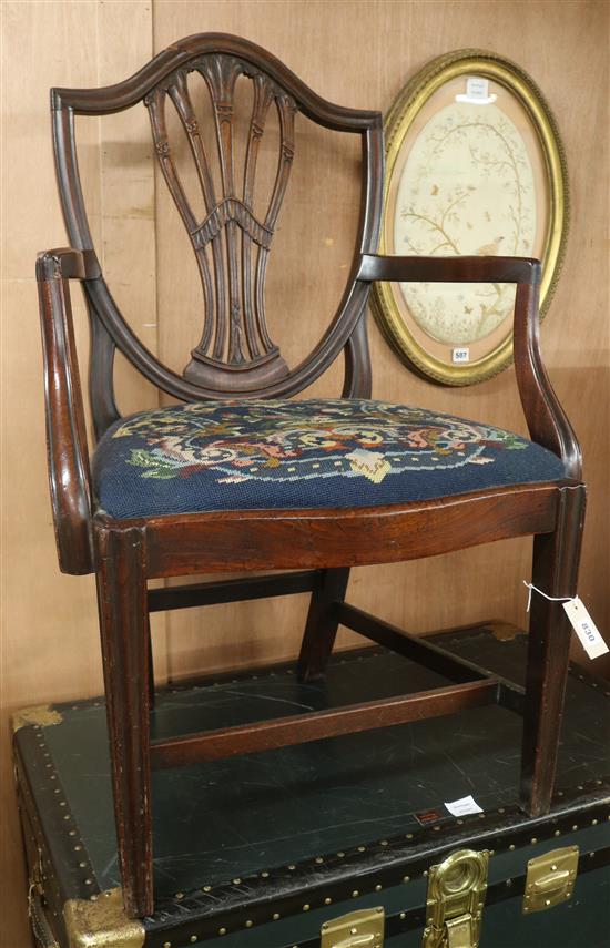 A Hepplewhite style mahogany shield back elbow chair